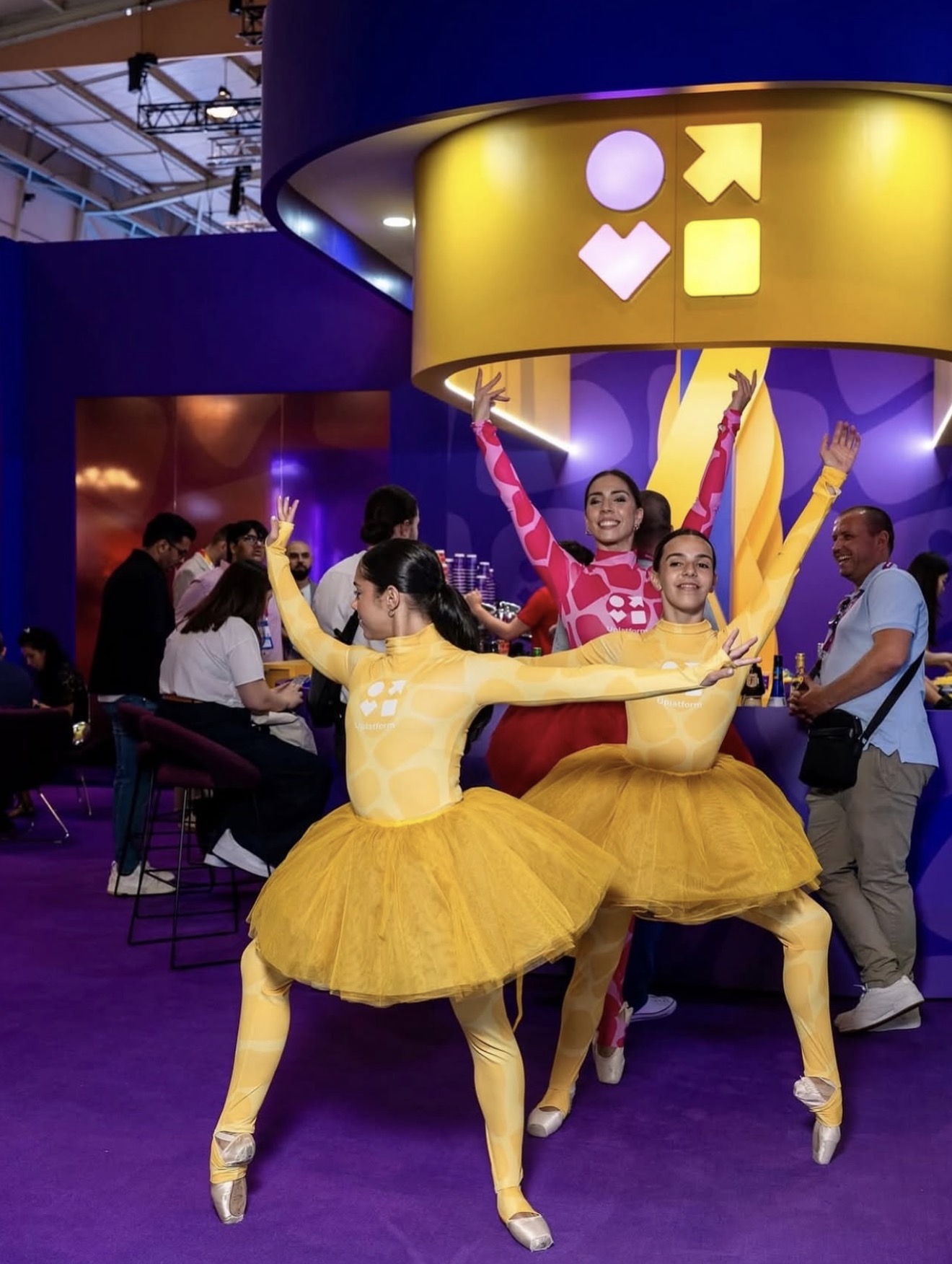 Tres bailarinas con tutús de colores en stand: iGB Londres.